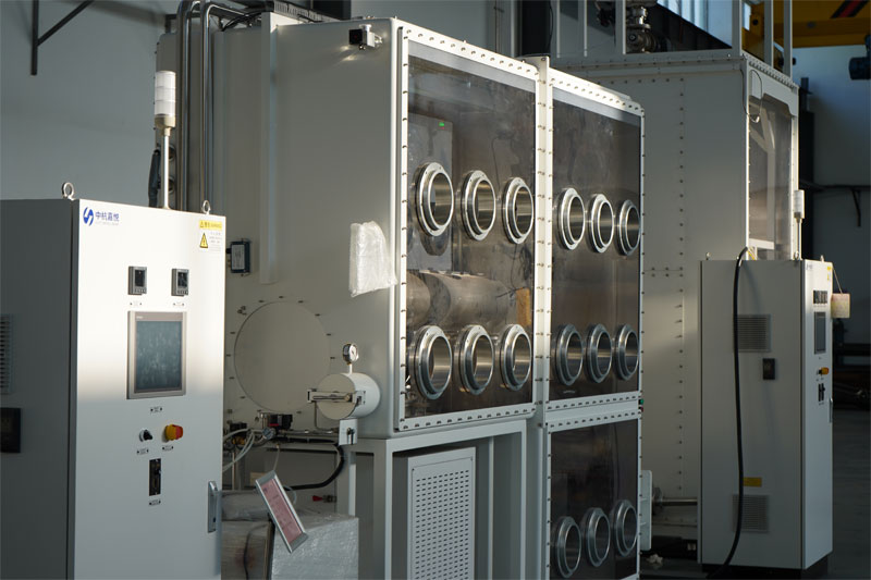 A large-scale industrial glovebox system by CHJT, featuring a multi-port processing chamber connected to a main control panel. A large-scale industrial glovebox system by CHJT, featuring a multi-port processing chamber connected to a main control panel.