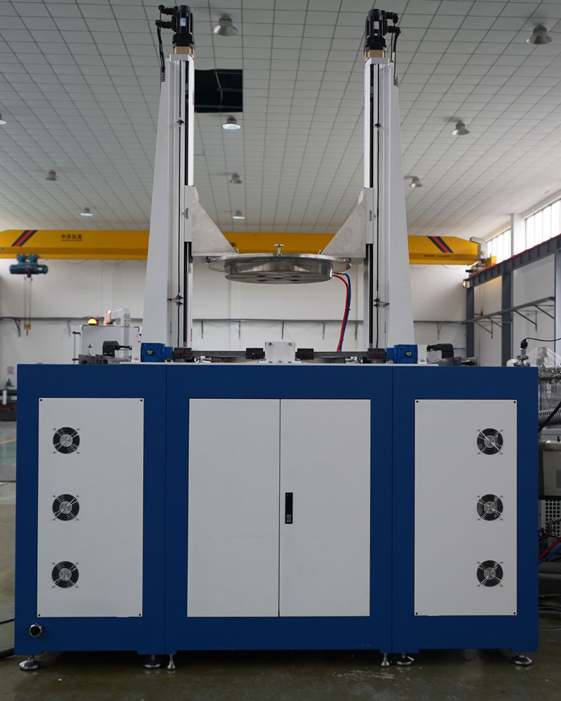 A large CHJT industrial machine with a blue and white base and two tall vertical arms lifting a large, circular metal component in a factory A large CHJT industrial machine with a blue and white base and two tall vertical arms lifting a large, circular metal component in a factory